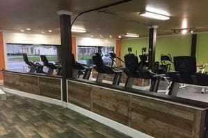 Cardio row and front desk at Absolute Fitness in Brazoria, TX